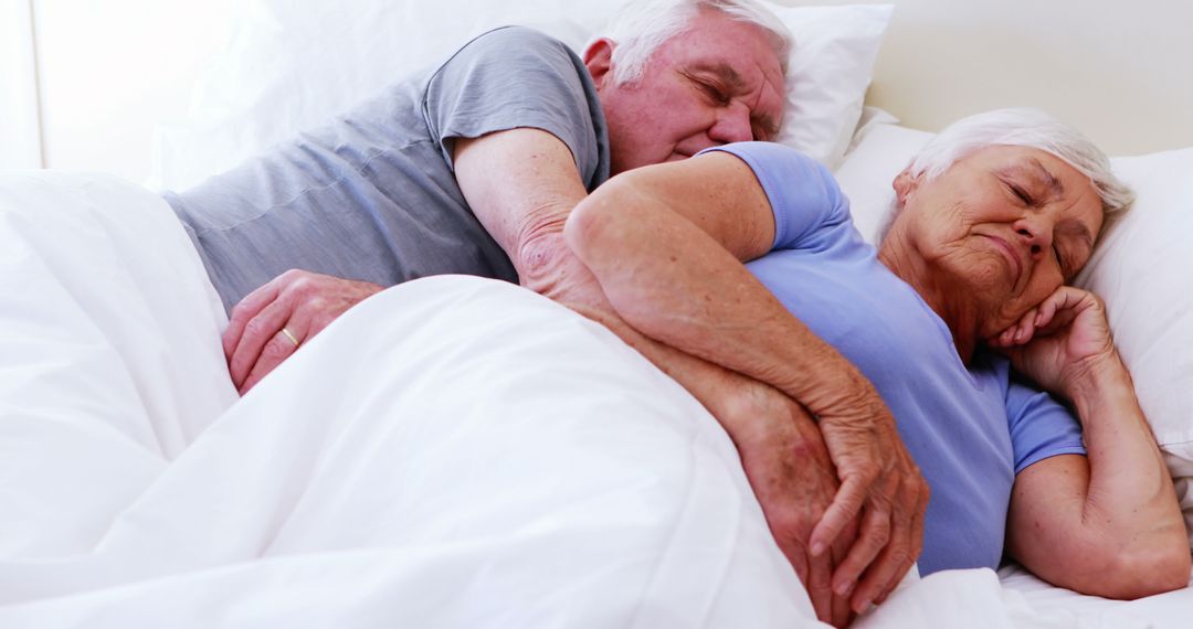 Peaceful Elderly Couple Sleeping in Bed