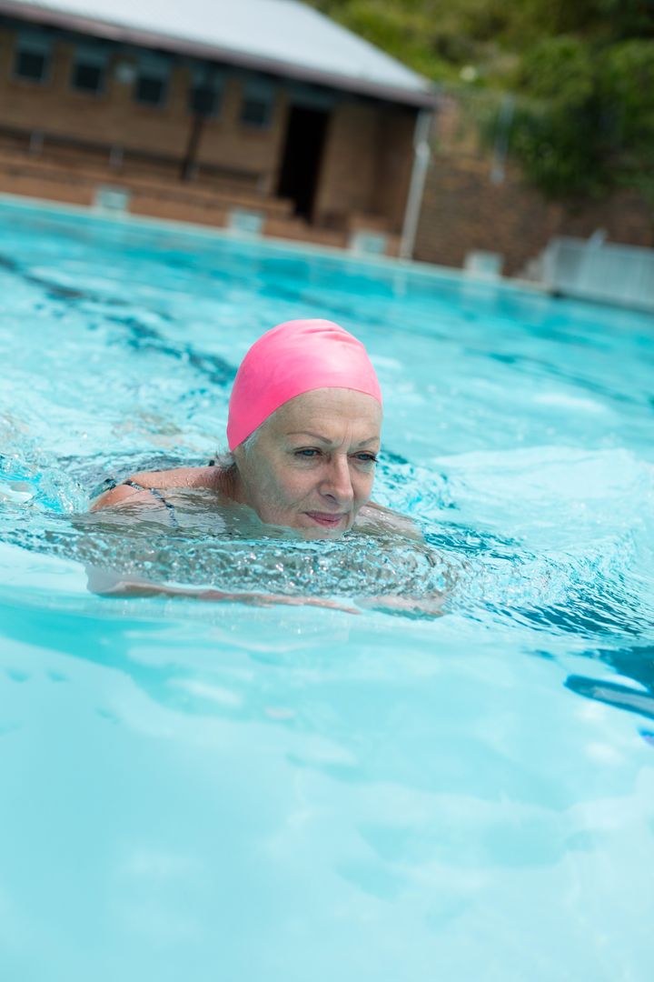 Senior woman wearing cap while swimming in pool - Free Images, Stock Photos and Pictures on Pikwizard.com