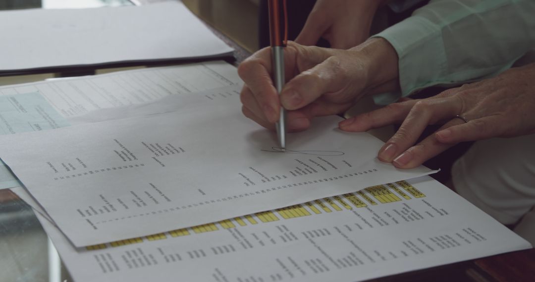 Couple Signing Financial Documents at Home
