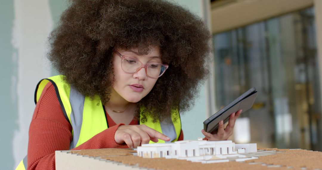 Female Architect Reviewing Building Model at Construction Site - Free Images, Stock Photos and Pictures on Pikwizard.com