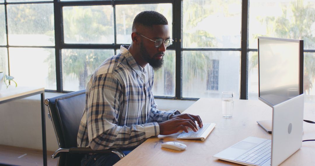 Business Professional Typing at Office Desk with Laptop