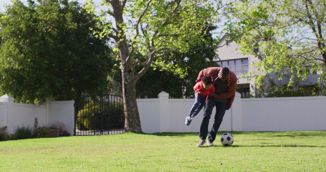 Father Playing Soccer with Son in Sunny Backyard - Free Images, Stock Photos and Pictures on Pikwizard.com