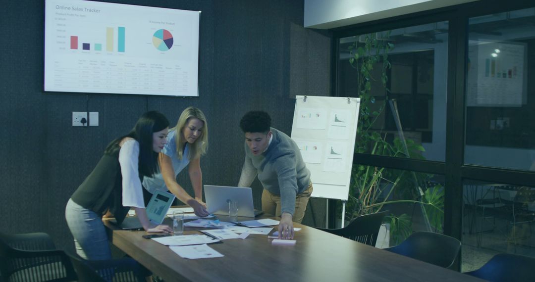 Diverse Team Collaborating on Sales Data in Modern Office