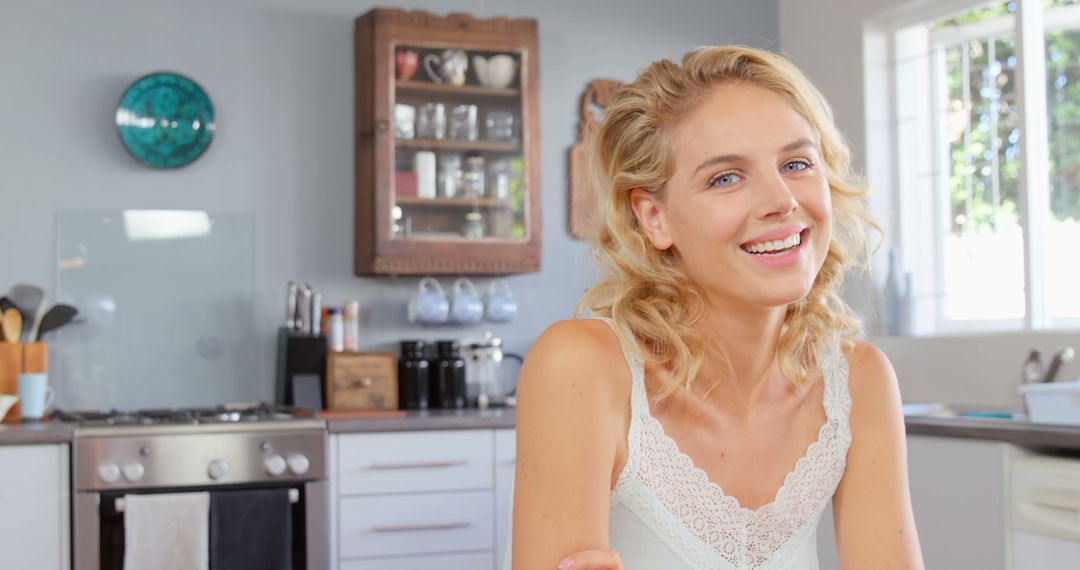 Smiling Woman Enjoying Morning in Bright Modern Kitchen - Free Images, Stock Photos and Pictures on Pikwizard.com