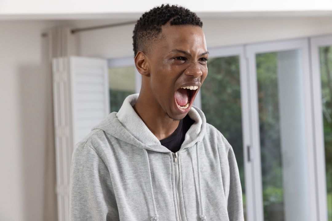 Energetic Man Expressing Intense Emotion at Home