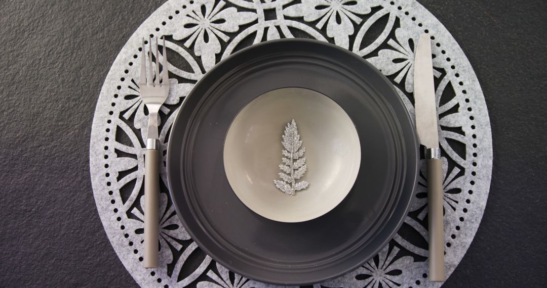 An elegant, minimalist place setting with a leaf motif and silverware exudes modern sophistication. - Free Images, Stock Photos and Pictures on Pikwizard.com