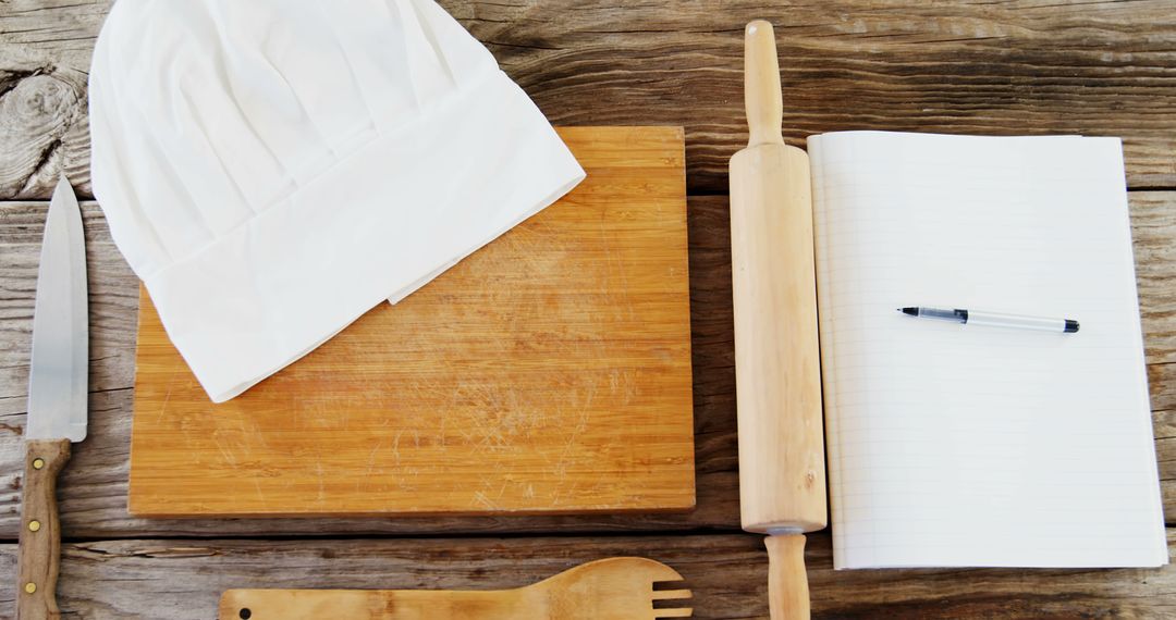 A chef's hat and rolling pin on a wooden surface imply recipe creation or menu planning. - Free Images, Stock Photos and Pictures on Pikwizard.com