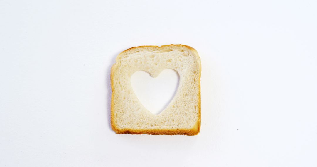 A heart-shaped hole in a bread slice against white symbolizes love for food or healthy eating. - Free Images, Stock Photos and Pictures on Pikwizard.com