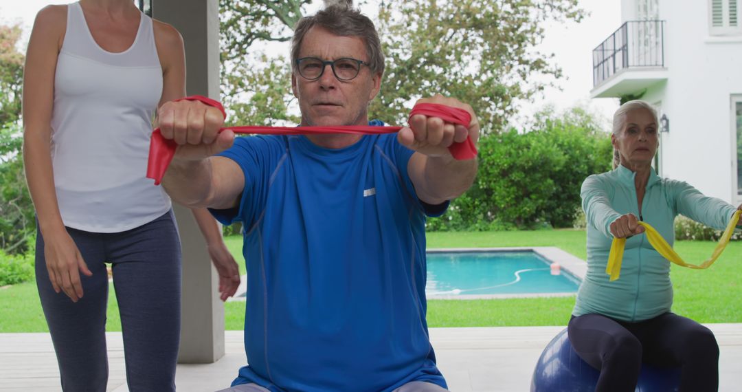 Active Seniors Exercising with Resistance Bands in Outdoor Fitness Class - Free Images, Stock Photos and Pictures on Pikwizard.com