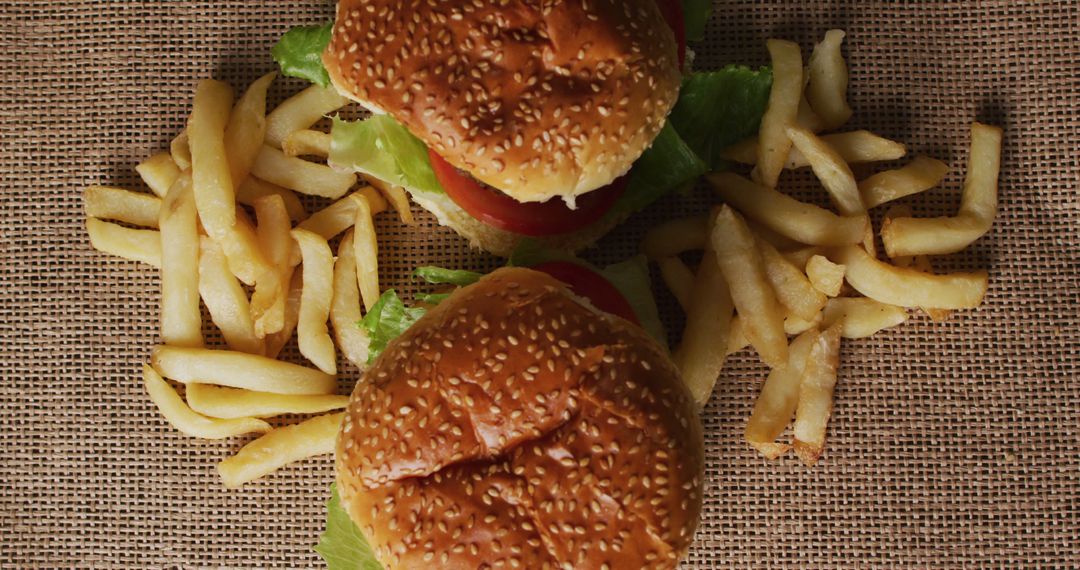 Top View of Classic Burgers and French Fries on Burlap - Free Images, Stock Photos and Pictures on Pikwizard.com