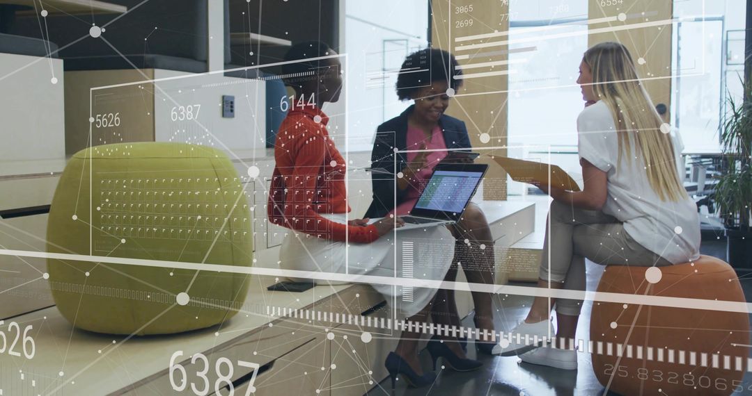 Three Women in Office Lounge Collaborating with Technology