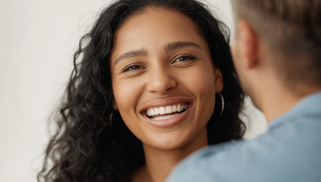Smiling Woman with Gold Hoop Earrings Engaging in Conversation