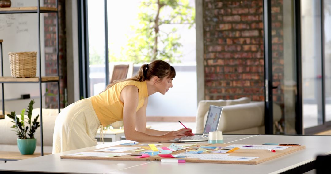 Woman Focusing in Modern Home Workspace for Creative Projects