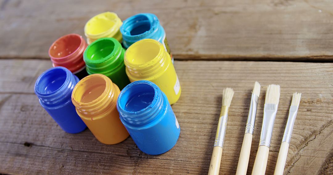 Acrylic Paint Jars and Brushes on Rustic Wooden Table - Free Images, Stock Photos and Pictures on Pikwizard.com