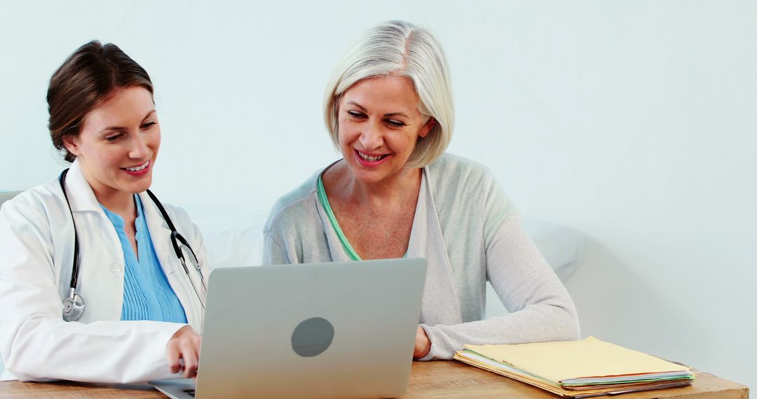 Doctor Discussing Medical Records with Senior Woman on Laptop - Free Images, Stock Photos and Pictures on Pikwizard.com