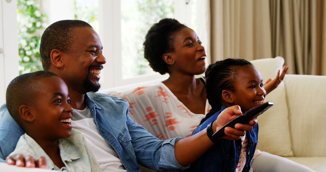 Cheerful African American Family Watching TV on Couch - Free Images, Stock Photos and Pictures on Pikwizard.com