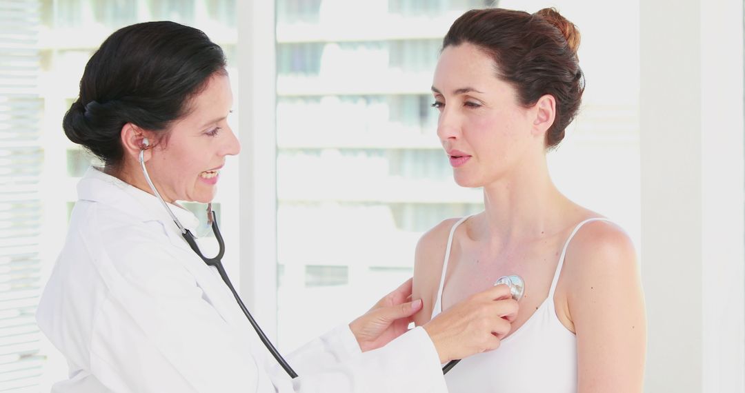 Female Doctor Examining Patient with Stethoscope in Medical Office - Free Images, Stock Photos and Pictures on Pikwizard.com