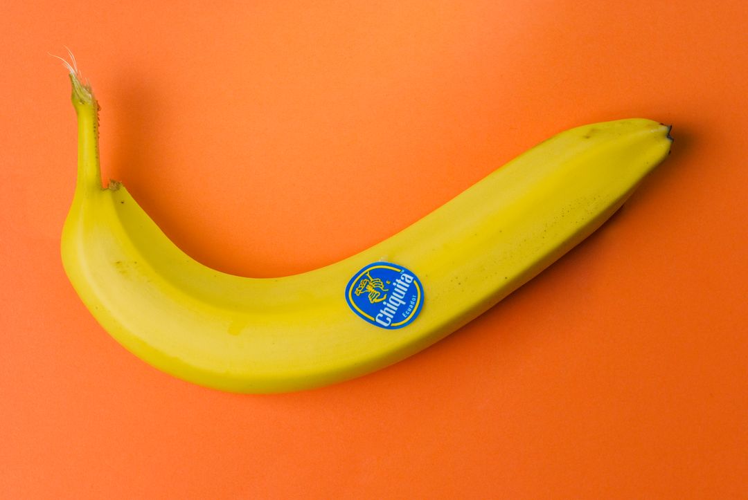 Single Yellow Banana on Vibrant Orange Background - Free Images, Stock Photos and Pictures on Pikwizard.com