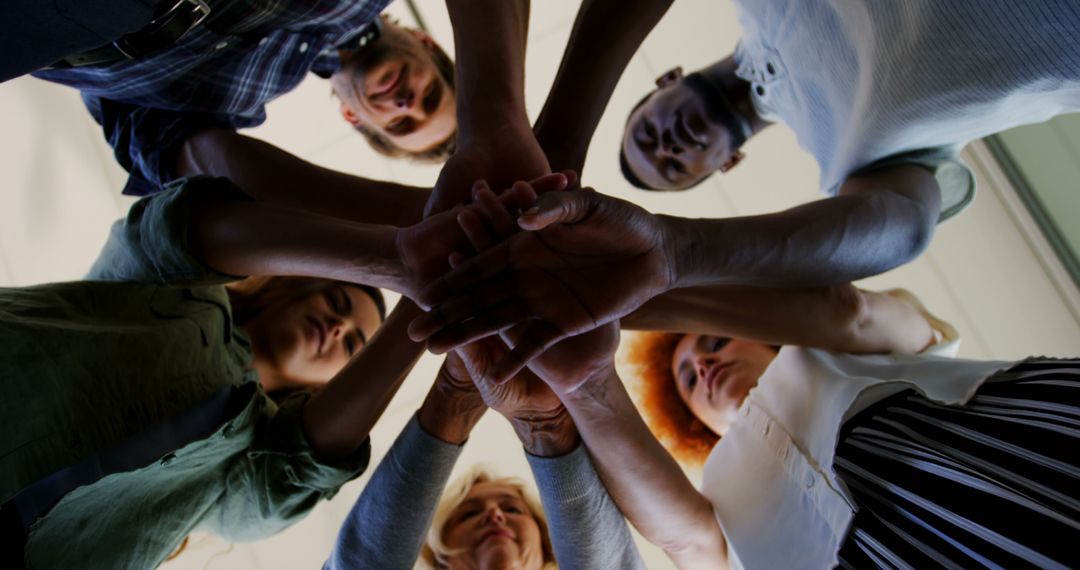A diverse team unites hands, symbolizing solidarity and shared commitment. - Free Images, Stock Photos and Pictures on Pikwizard.com