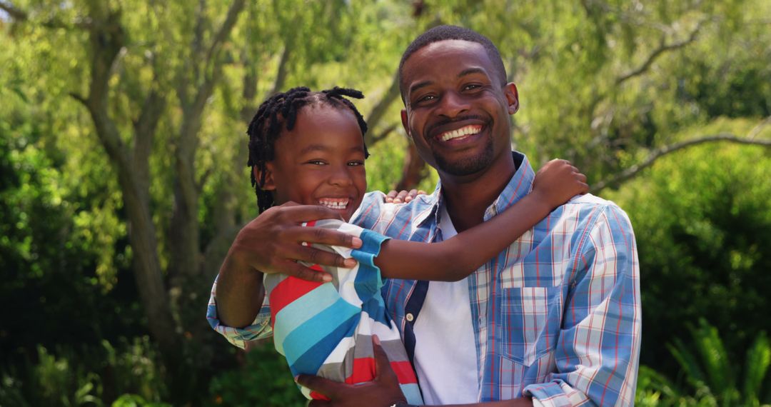 Happy African American Father Enjoying Time with Son Outdoors - Free Images, Stock Photos and Pictures on Pikwizard.com