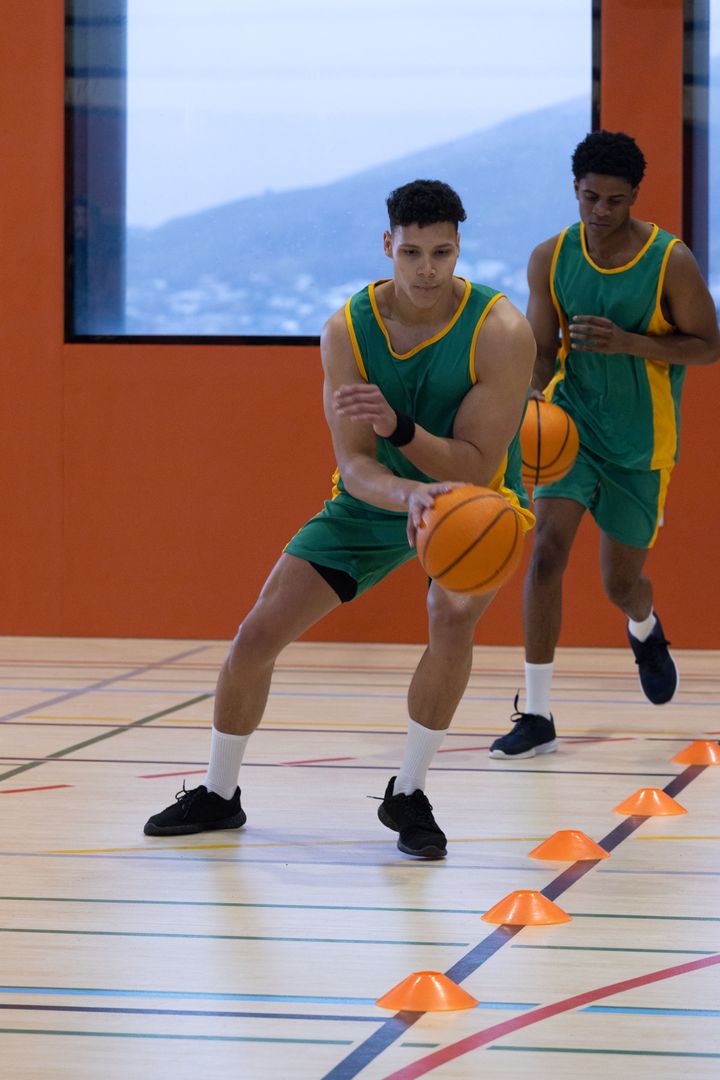 Athletes Dribbling Basketballs Through Cones for Agility Training