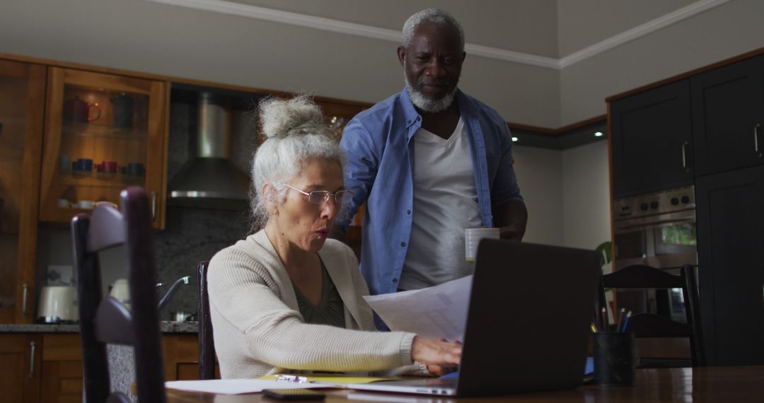 Elderly Couple Managing Finances Together in Cozy Kitchen - Free Images, Stock Photos and Pictures on Pikwizard.com