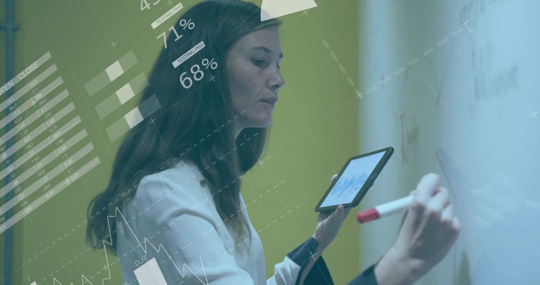 Business Analyst Writing on Whiteboard with Tablet for Data Visualization