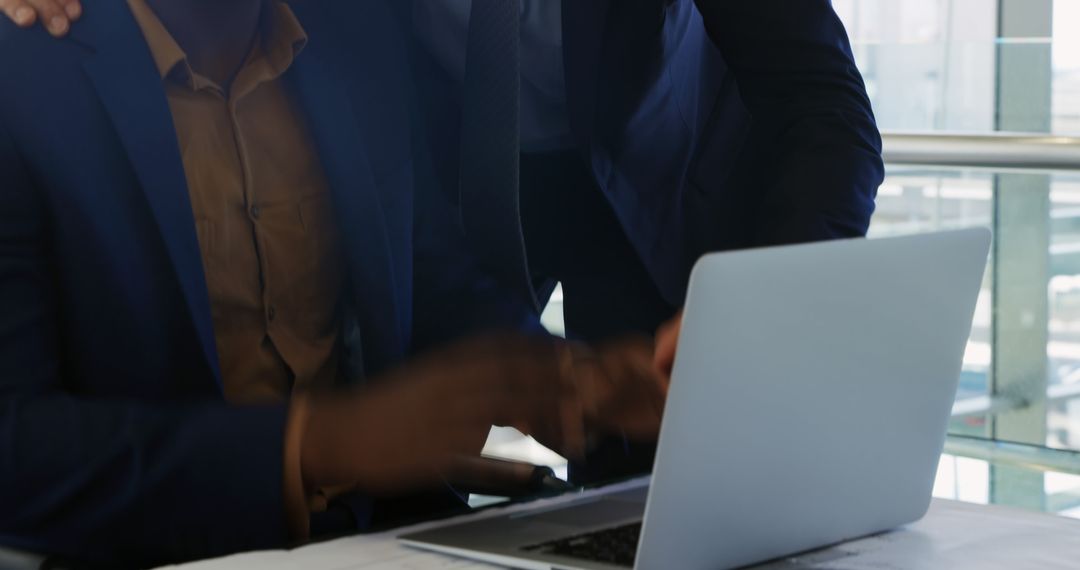 Collaborative Business Team Using Laptop in Modern Office