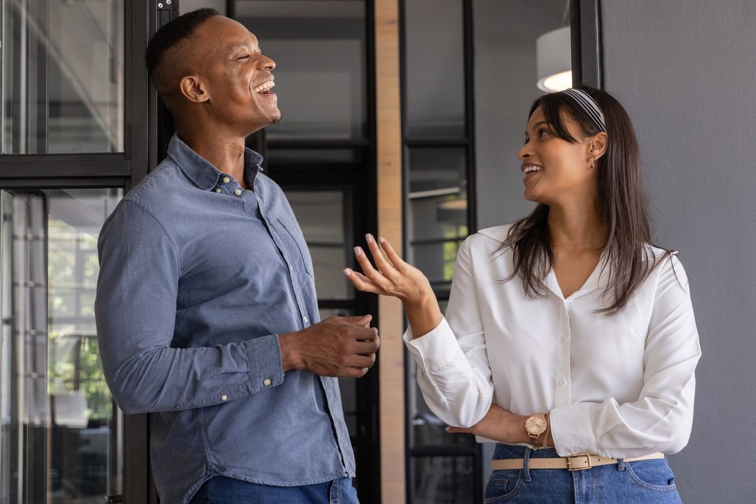 Friendly Coworkers Having Casual Conversation at Workplace