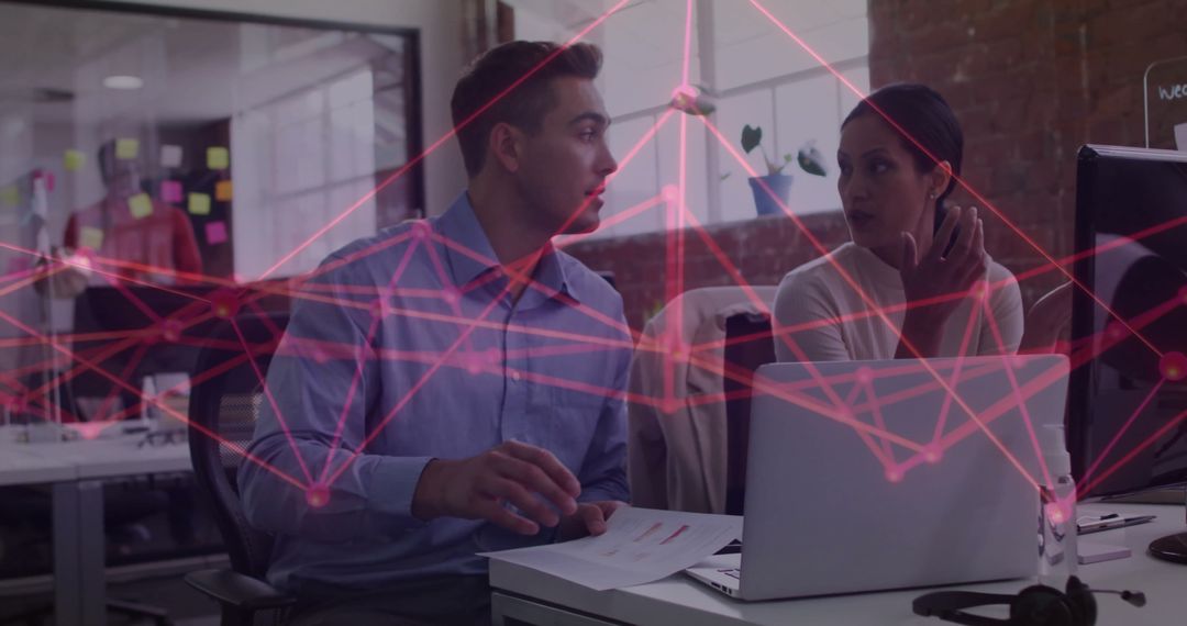 Collaborative Colleagues Discussing Data Trends at Office Desk