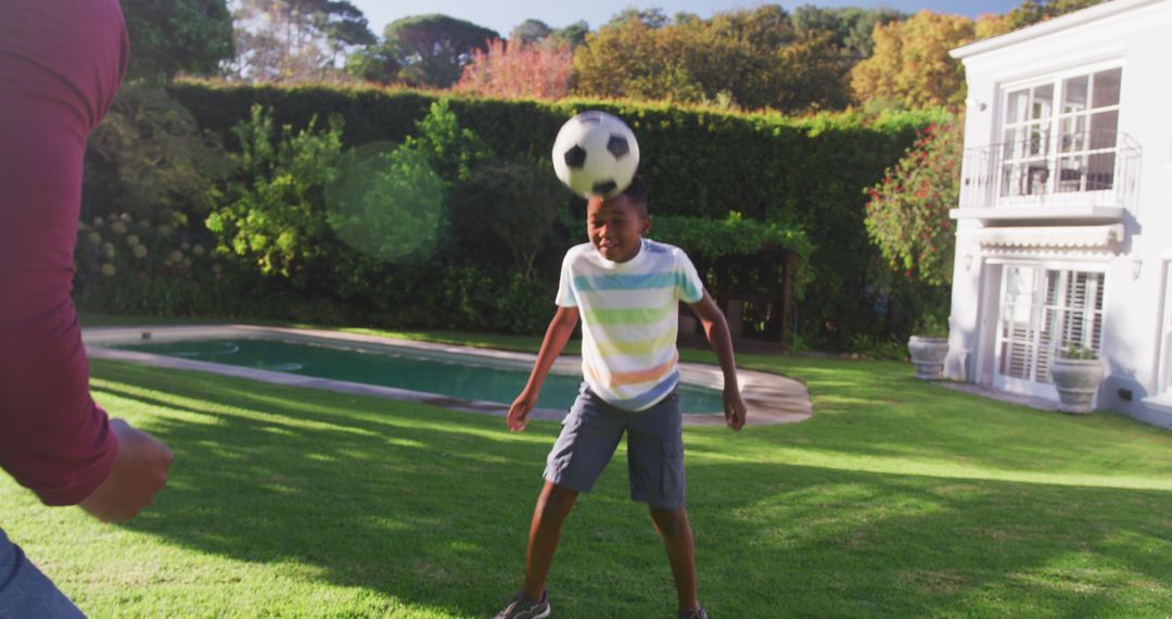 Boy Playing Soccer in Yard, Heading a Soccer Ball - Free Images, Stock Photos and Pictures on Pikwizard.com