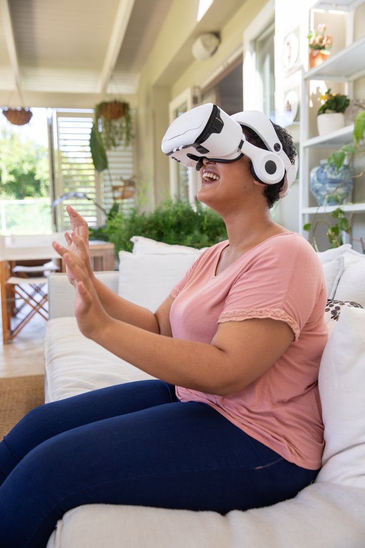 Woman Enjoying Immersive VR Experience in Sunlit Living Space