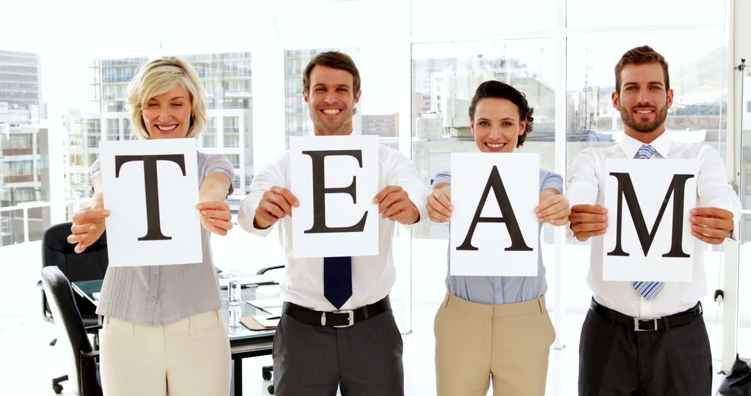 Successful Business Team Holding Letters T E A M in Office - Free Images, Stock Photos and Pictures on Pikwizard.com