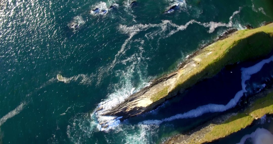 Aerial photo showcases the striking contrast and beauty of waves meeting a craggy coast. - Free Images, Stock Photos and Pictures on Pikwizard.com