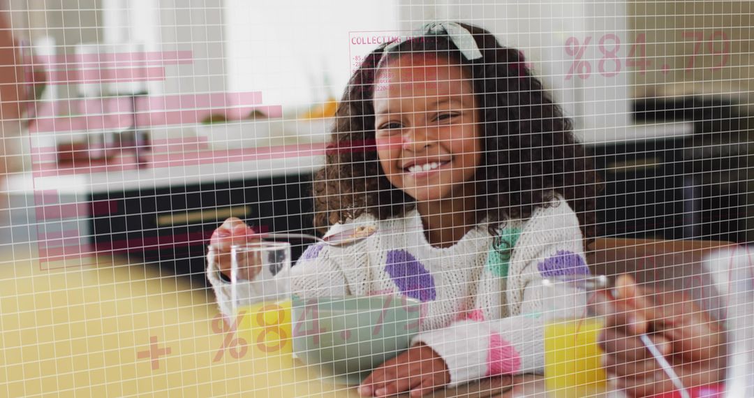 Smiling girl scooping cereal at breakfast with orange juice in sunny family kitchen at table