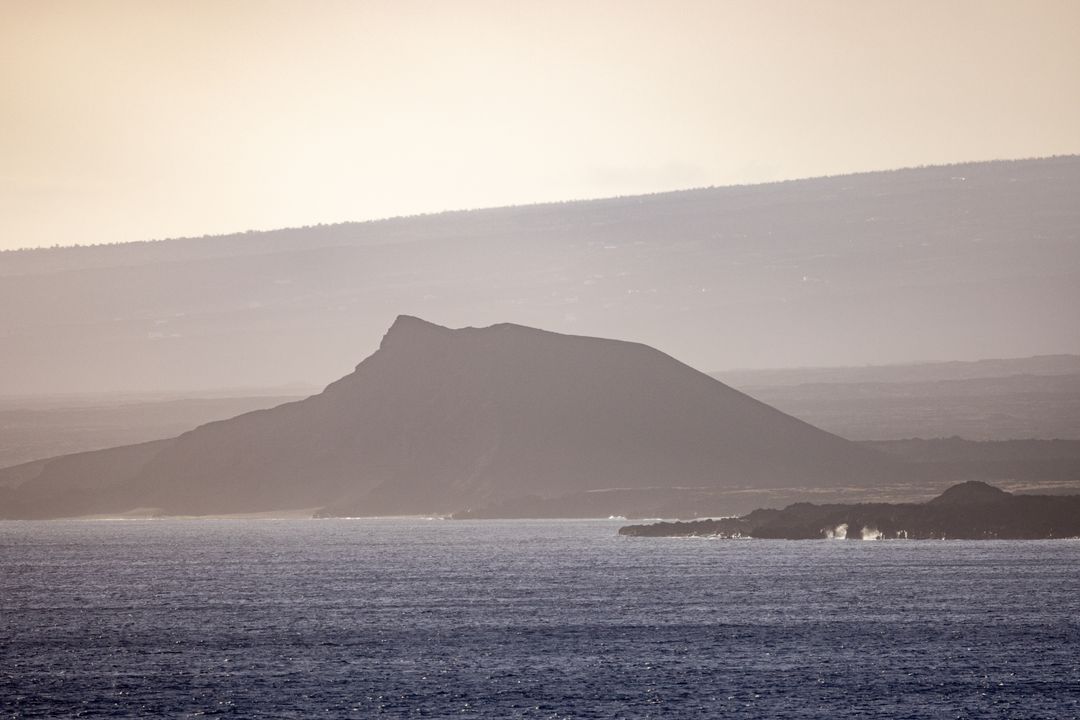 Mystical coastal mountain at dusk with calm beach