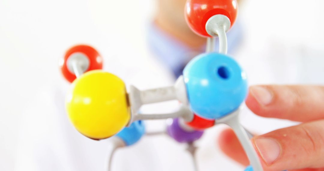 Scientist Analyzing Colorful Molecule Model