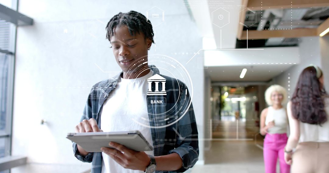Young man tapping tablet for digital banking with futuristic bank icon overlay
