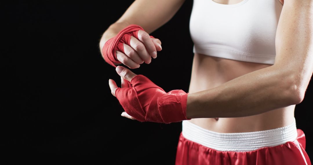 Athlete Wrapping Hands with Boxing Tape Preparing for Training