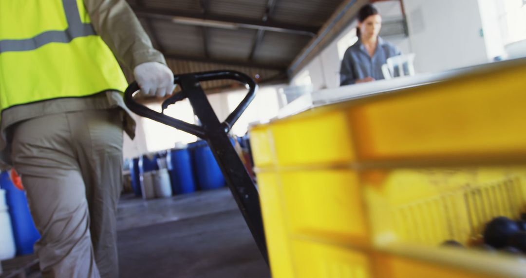 Warehouse Worker Operating Pallet Jack in Industrial Building - Free Images, Stock Photos and Pictures on Pikwizard.com