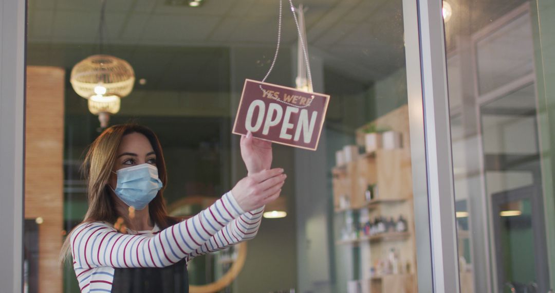 Restaurant Showing Open Sign by Staff Wearing Mask - Free Images, Stock Photos and Pictures on Pikwizard.com