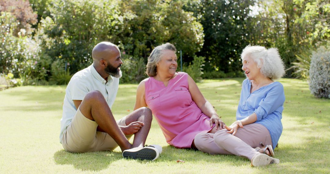 Senior Friends Enjoying Relaxing Conversation in Park