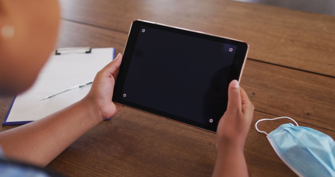 Hands Holding Digital Tablet with Blank Screen on Wooden Table - Free Images, Stock Photos and Pictures on Pikwizard.com