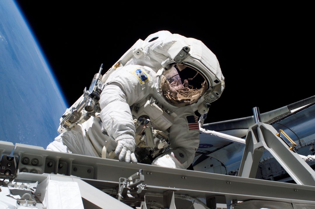 Astronaut Performing Spacewalk Near International Space Station - Free Images, Stock Photos and Pictures on Pikwizard.com
