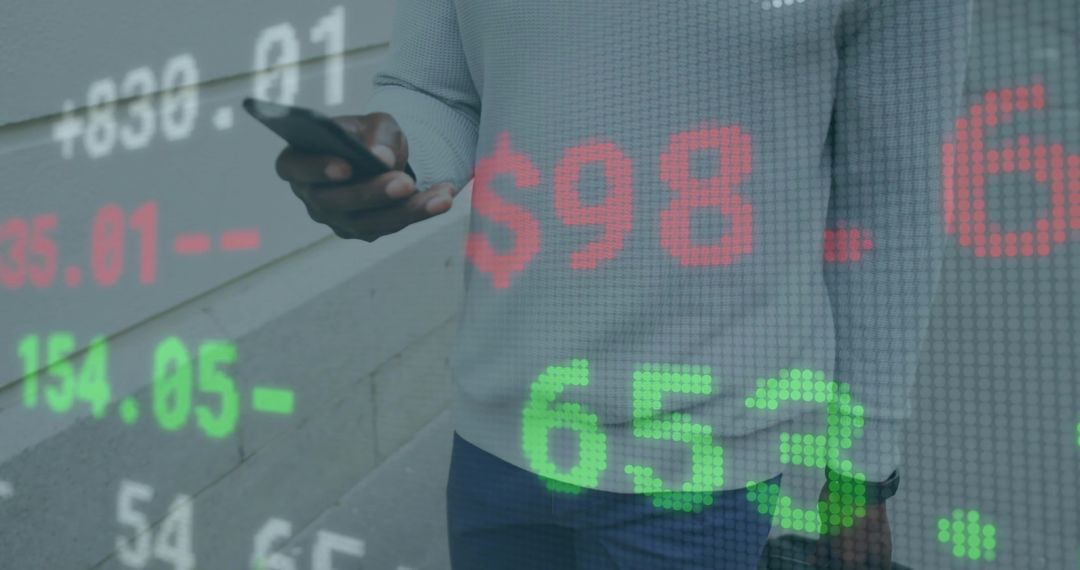 Businessman Analyzing Data with Stock Market Overlay and Smartphone