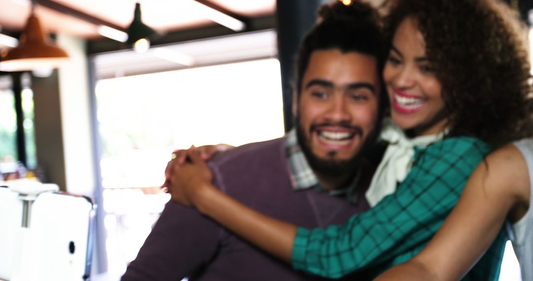 Happy Couple Sharing Joyful Hug with Blurred Background