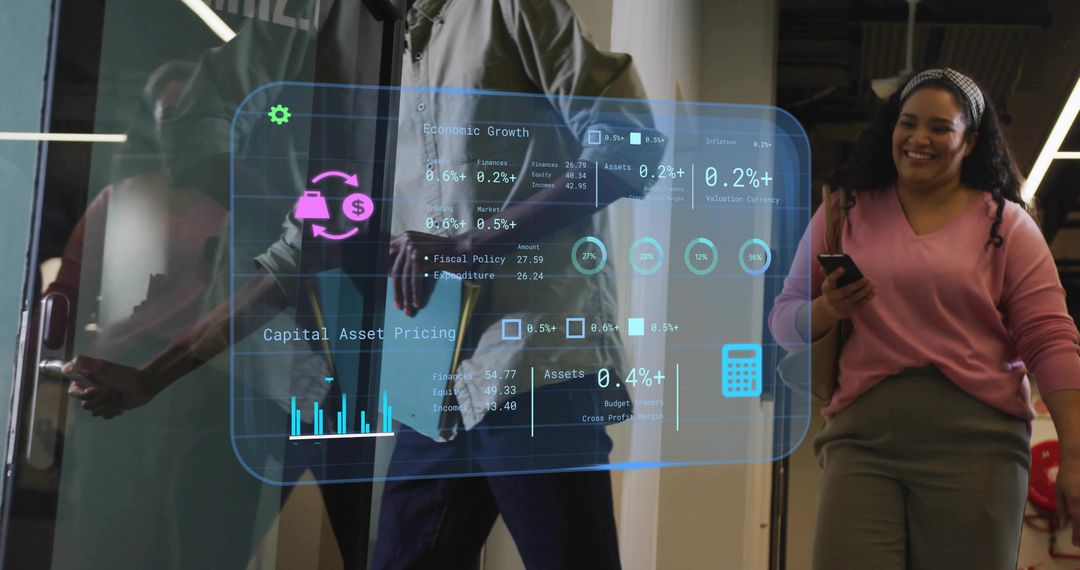 Office coworkers walking through glass door while viewing holographic business dashboard