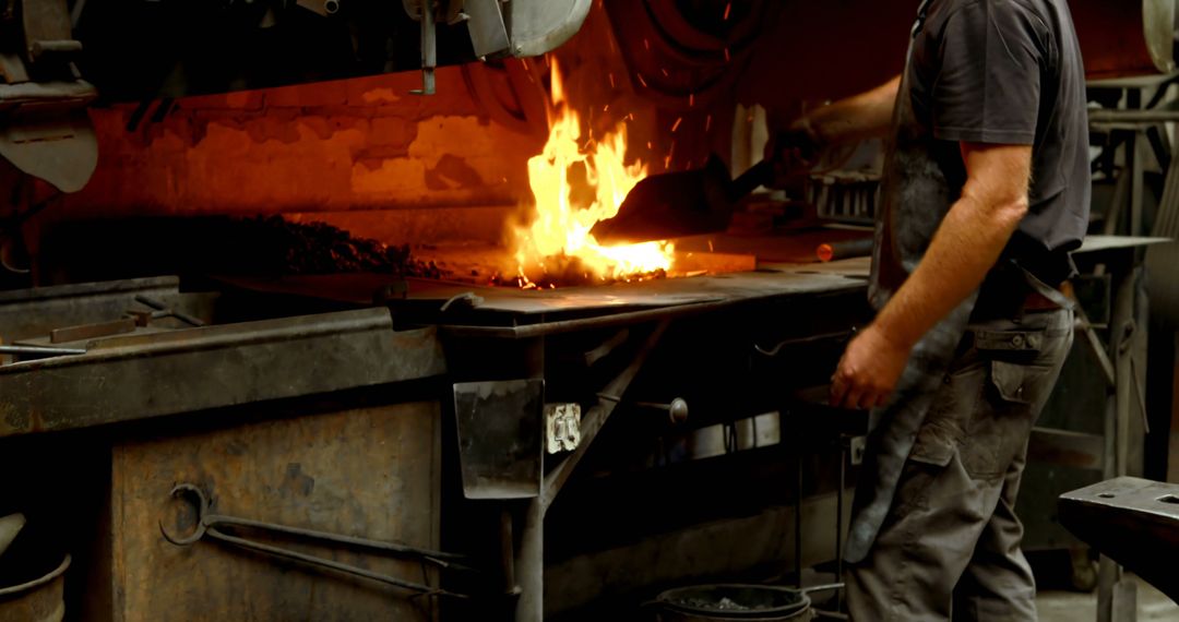 Manual Laborer Working at Forging Station with Open Flame - Free Images, Stock Photos and Pictures on Pikwizard.com