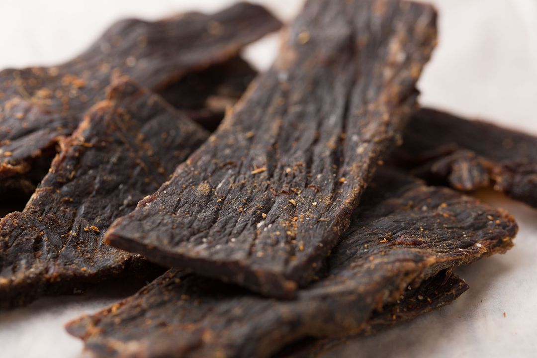 Close-Up of Crispy Beef Jerky Slices on White Background - Free Images, Stock Photos and Pictures on Pikwizard.com