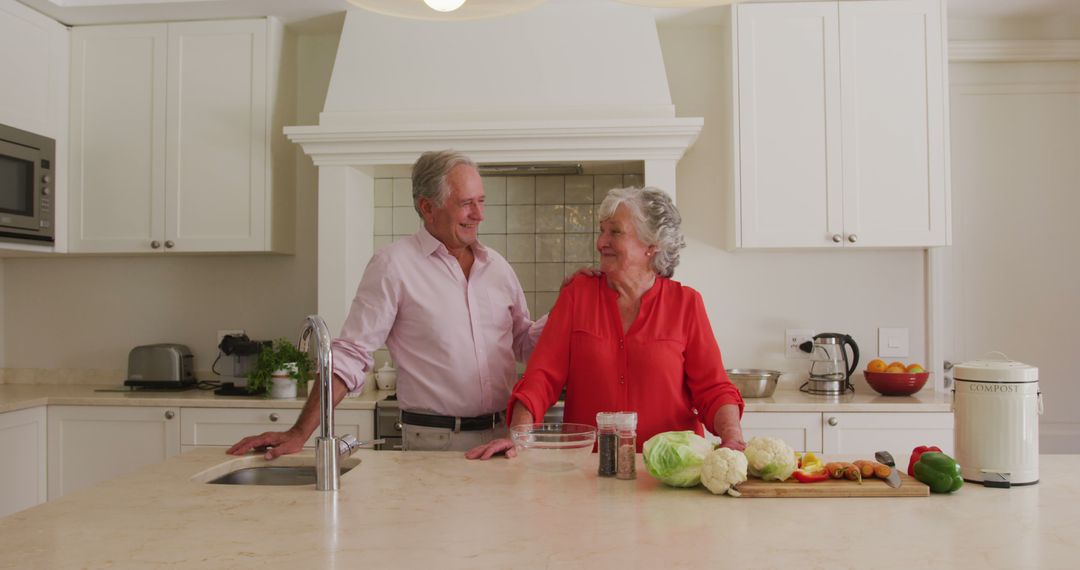 Portrait of caucasian senior couple smiling while standing in the kitchen at home - Free Images, Stock Photos and Pictures on Pikwizard.com